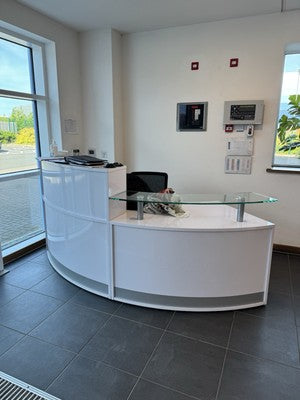 Modern White Curved Reception Desk with Glass Countertop and Built-In Storage